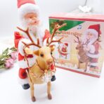 Decoratiune Mos Craciun, Embo, Animat, care Canta si Danseaza, cu Saculet, pe Ren, Imbracat Festiv, 28x21x10 cm, Rosu - imagine 6